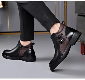Detailed side view of stylish men's leather boots with metal buckles and side zipper