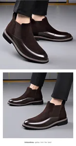 Macro view of men's brown Chelsea boots featuring stylish suede and leather splicing.