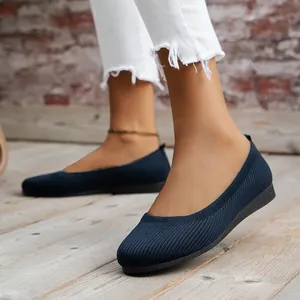 Detailed view of navy blue knit flat shoes featuring a round toe and breathable mesh texture