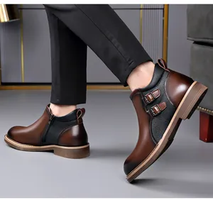 Detail view of men's brown leather mid-top boots with double buckles and side zipper