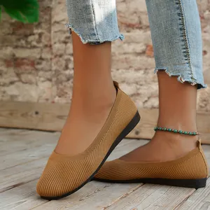 Detailed close-up of women's tan knitted round toe flat shoes with ribbed texture