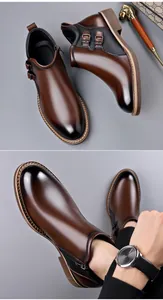 Detail view of brown leather Martin boots with side zipper and decorative metal buckles.