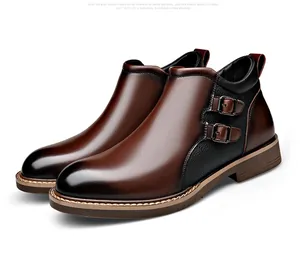 Detailed side view of men's brown leather boots featuring dual metal buckle accents.
