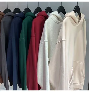 Detail of plain oversized hoodies in various colors without drawstrings.
