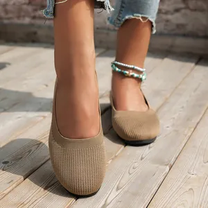 Detailed view of women's breathable khaki fly-woven round toe flat shoes on a wooden deck