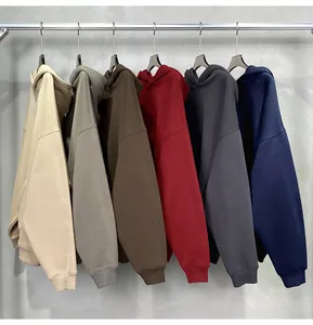 Close-up view showing multiple solid color oversized hoodies hanging on a retail rack