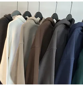Detailed view of multiple color options for mens oversized solid hoodies on hangers.