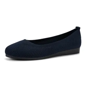Close-up side view of navy blue knit ballet flats with a comfortable round toe design