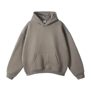 Detail showing a solid grey oversized hoodie with a drawstring-less hood and pocket