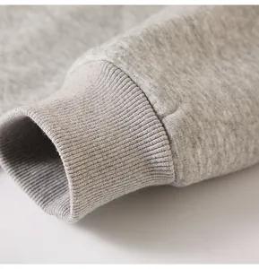 High-quality macro view of the grey ribbed cuff detail on a premium cotton blend hoodie