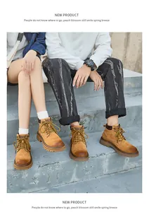 Couple wearing vintage leather yellow work boots sitting on concrete steps outdoors.
