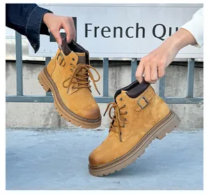 Detailed view of yellow leather Martin boots with thick lug soles and metallic buckle