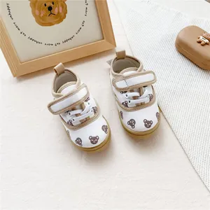 Detail of cute bear pattern children's canvas shoes with velcro strap and soft sole