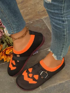 Close-up detail of breathable fly-knit loafers featuring orange Halloween pumpkin face