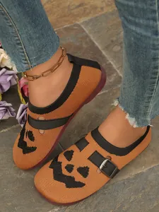 Close-up detail of breathable orange fly woven shoes with black pumpkin face print