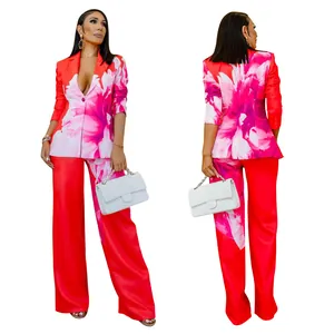 Front and back view of vibrant red floral print two-piece blazer and wide-leg pants set.
