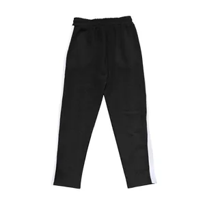 Détail d'un pantalon décontracté jacquard noir pour homme avec bandes latérales blanches.