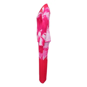 Side view of vibrant pink floral print blazer and matching trousers suit set for women