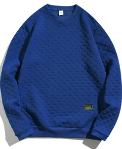 Detail of the 3D checkered texture on the royal blue heavy men's crewneck sweatshirt