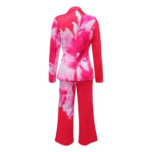 Back view of women's vibrant pink blazer and trousers set with white floral print