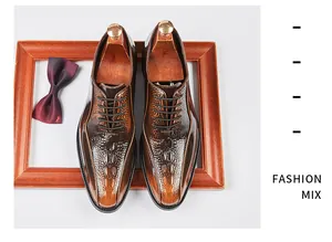 Close-up of premium brown leather oxfords with crocodile pattern and pointed toe design.
