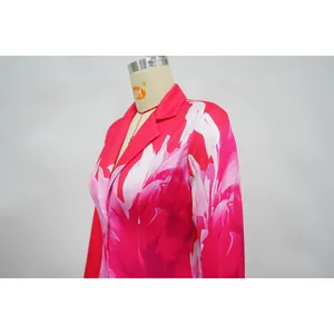 Detail view of women's floral print blazer with vibrant pink and white abstract pattern