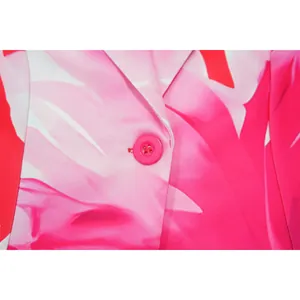 Close-up detail of vibrant pink floral print blazer fabric with matching button