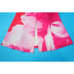 Macro detail view of vibrant pink and white floral print hemline on flared suit trousers