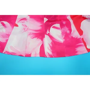 Macro detail showing vibrant pink floral print and neat stitching on a pleated garment hem