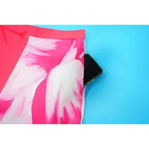 Close-up detail of a functional side pocket on vibrant floral print suit pants for women
