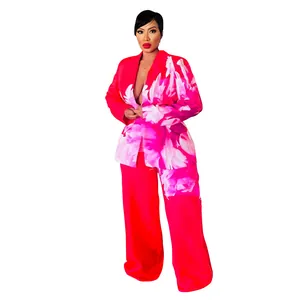Women's vibrant red floral print two-piece blazer and wide-leg trouser suit set.
