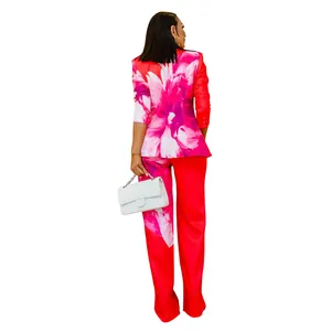 Back view of a vibrant red floral print blazer and trousers two-piece women suit