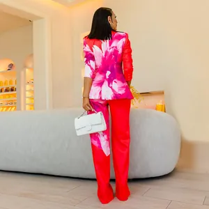 Detailed back view of a chic women's two-piece red suit set with pink floral prints.
