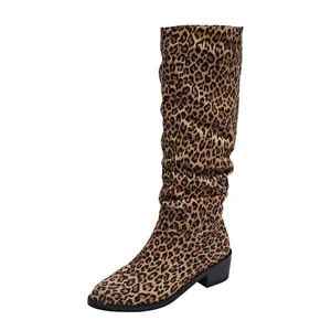 Close-up detail of leopard print knee-high boot with stylish slouchy design and block heel.