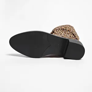 Detailed view of leopard print fashion boot showing anti-slip black sole and block heel