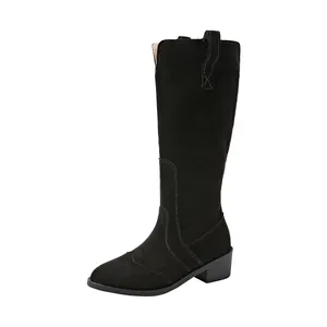 Detailed side view of black suede pointed toe tall boots featuring decorative stitching