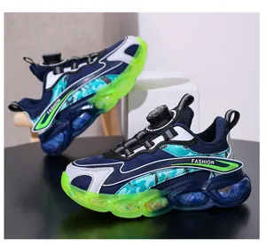 Close-up of stylish boys' sports shoes with rotary buckle and lime green jelly sole.