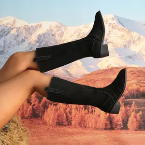 Close-up detail showing elegant black suede knee-high boots with pointed toe and block heel.
