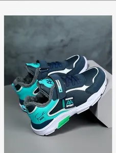 Close-up detail of boys' warm fleece-lined winter sports sneakers in blue and teal colors
