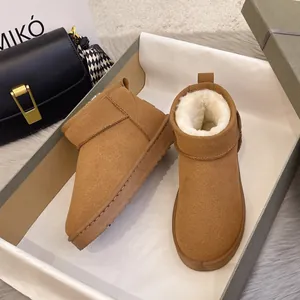Chestnut brown suede snow boots with warm faux fur lining in a stylish gift box setup.