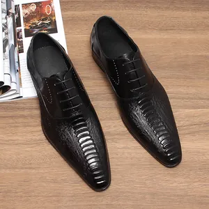 Chaussures habillées élégantes en cuir noir à motif crocodile avec bouts pointus.