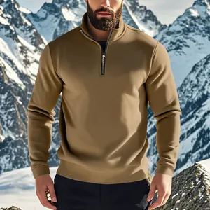Close-up of a men's khaki quarter-zip fleece sweatshirt against a snowy mountain.