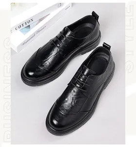 Detailed close-up of men's black business leather shoes with hand-rubbed texture and lace-up design