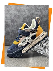 Close-up view of a stylish children's durable leather sports shoe in navy blue and yellow