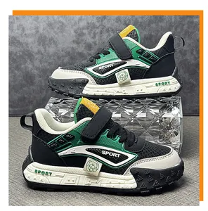 Detail showing mesh and synthetic leather textures of green kids' sporty sneakers