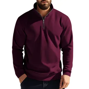 Detail view of men's maroon quarter-zip sweatshirt showing fabric texture and fit.