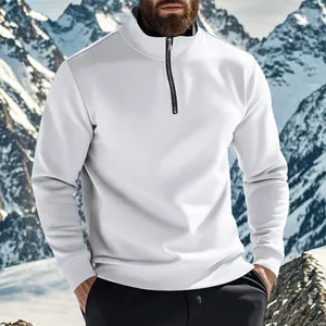 Close-up view of men's white half-zip fleece sweatshirt against a snowy mountain backdrop