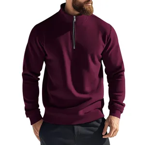 Close-up detail of a men's burgundy half-zip sweatshirt with a premium stand collar