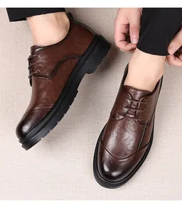 Detailed close-up view of men's brown textured leather dress shoes for formal weddings