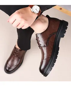 Close-up of brown men's business leather shoes with unique hand-grabbed texture.